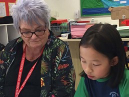 Ros with child in classroom in Hong Kong