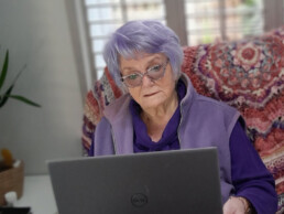 Ros working on laptop in a chair
